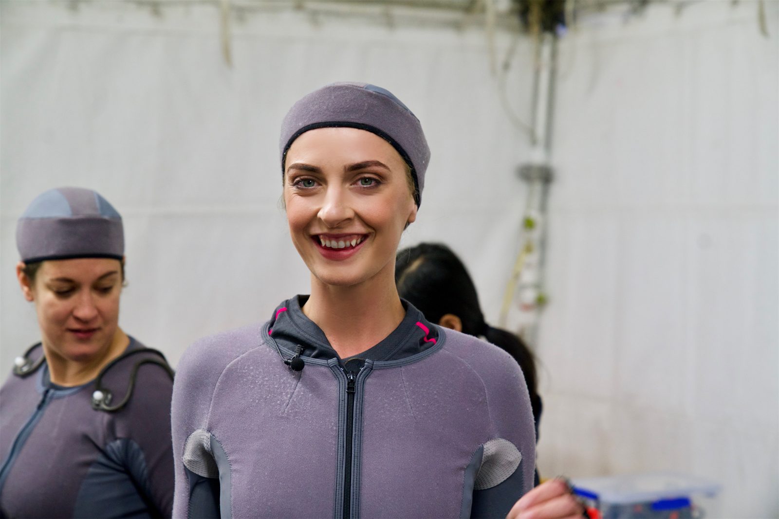 Emily Riedel smiling in a motion-capture suit