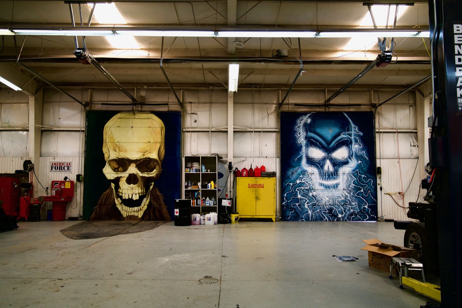 A garage with giant skull murals on the back wall, photographed as a background plate