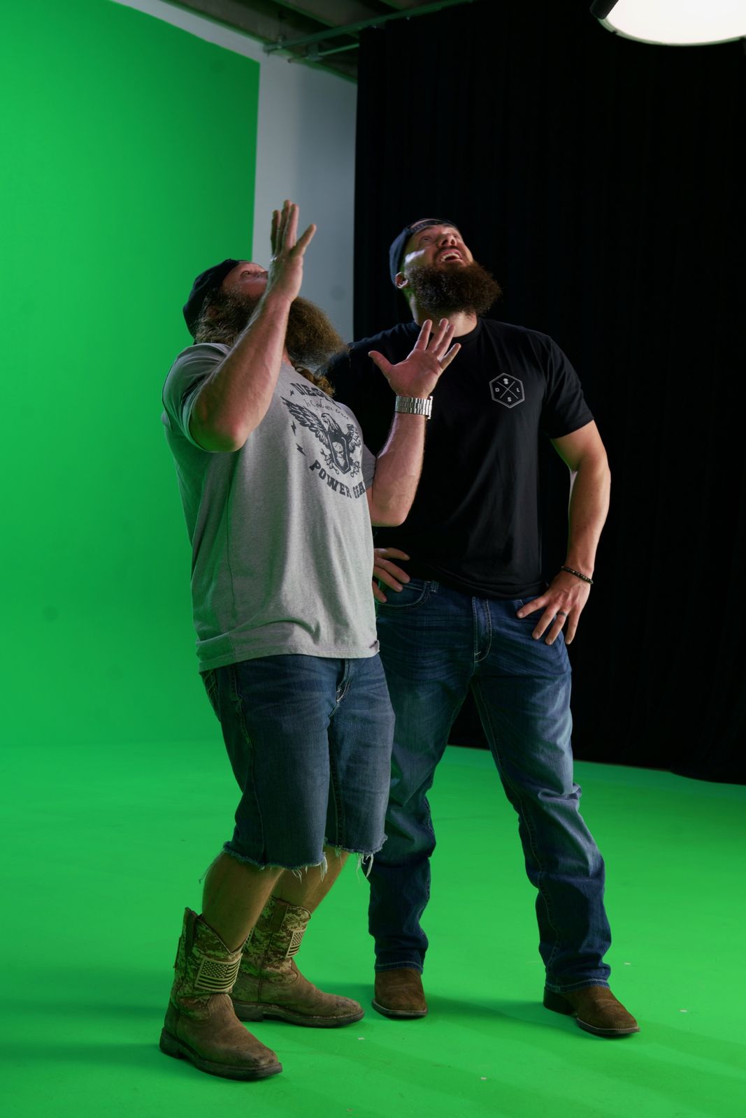 Heavy D and Diesel Dave point up at an imaginary giant on green screen