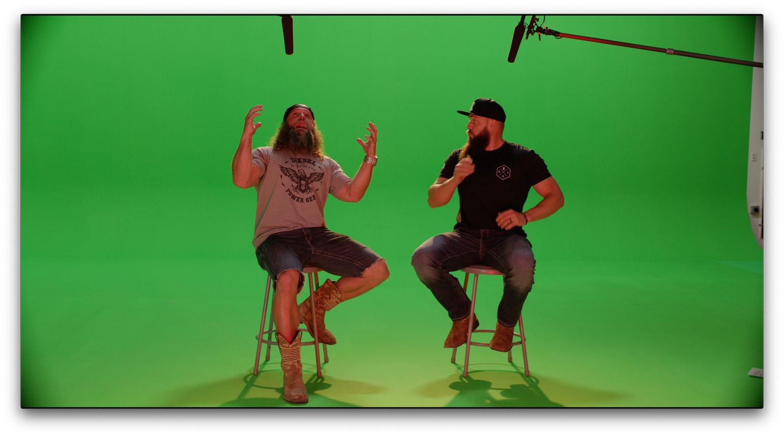 Heavy D and Diesel Dave gesturing on stools against green screen